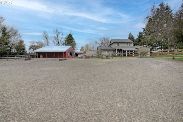 view of yard with an outbuilding, an outdoor structure, and fence