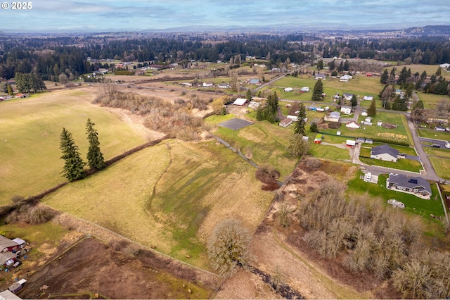 birds eye view of property featuring a rural view