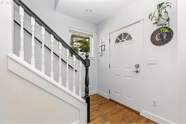 10272 NW Edgewood Dr, Portland, OR 97229 - foyer with wood finished floors, baseboards, and stairs