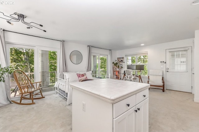 10272 NW Edgewood Dr, Portland, OR 97229 - kitchen with tile countertops, light colored carpet, white cabinets, and recessed lighting