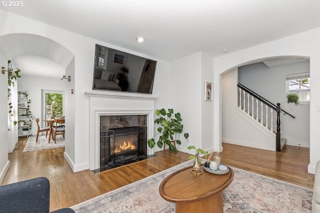 10272 NW Edgewood Dr, Portland, OR 97229 - living area with wood finished floors, stairway, healthy amount of natural light, a fireplace, and recessed lighting