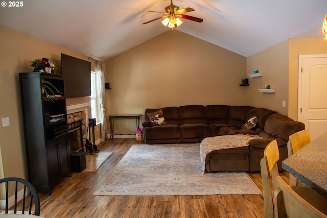 living room with hardwood / wood-style floors, vaulted ceiling, and ceiling fan