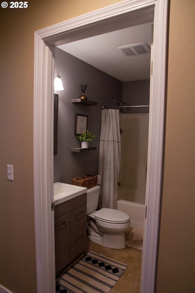 full bathroom with shower / tub combo with curtain, vanity, tile patterned flooring, and toilet