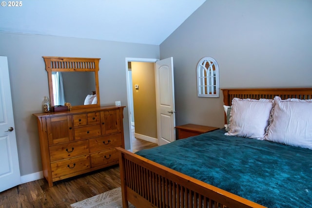 bedroom featuring dark wood-type flooring and vaulted ceiling