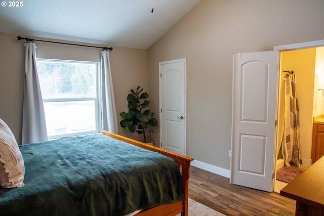 bedroom featuring lofted ceiling and hardwood / wood-style floors