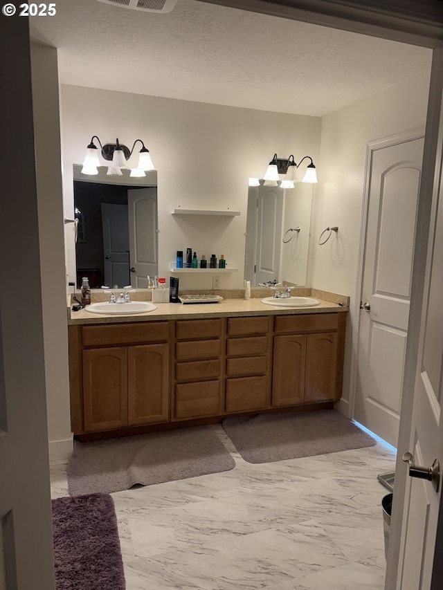 bathroom with vanity and a textured ceiling