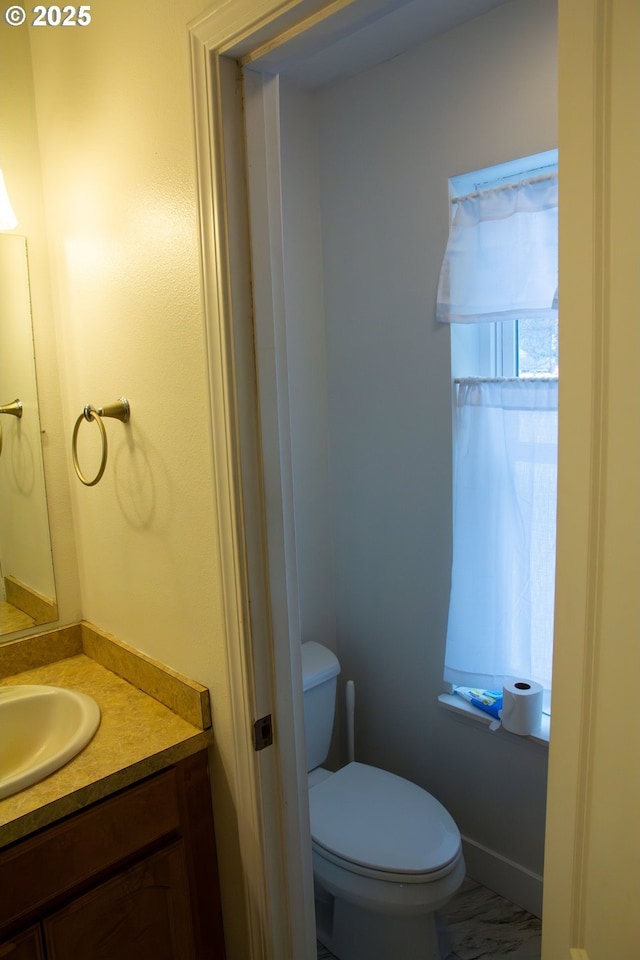 bathroom featuring vanity and toilet