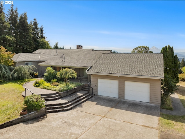 view of front of home featuring a garage and a chimney