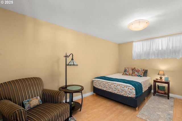 bedroom featuring baseboards and light wood-style floors