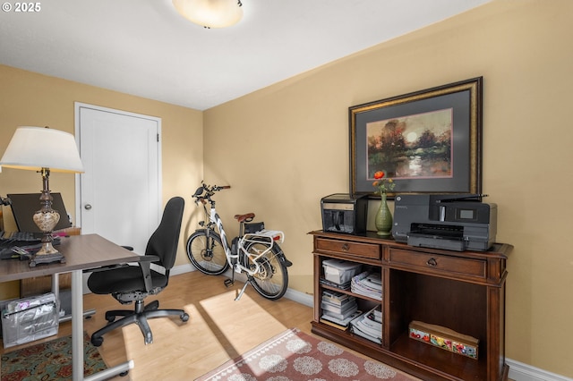 office space with baseboards and wood finished floors