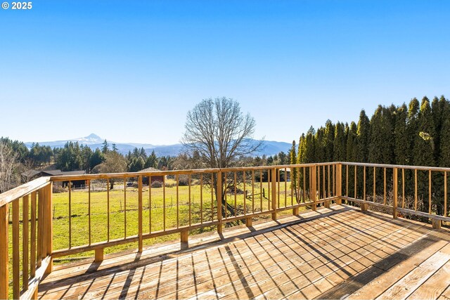 deck featuring a yard and a mountain view