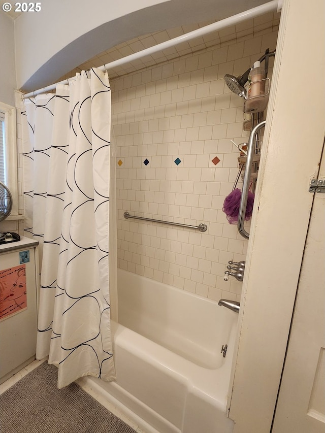 bathroom featuring shower / bathtub combination with curtain and tile patterned floors