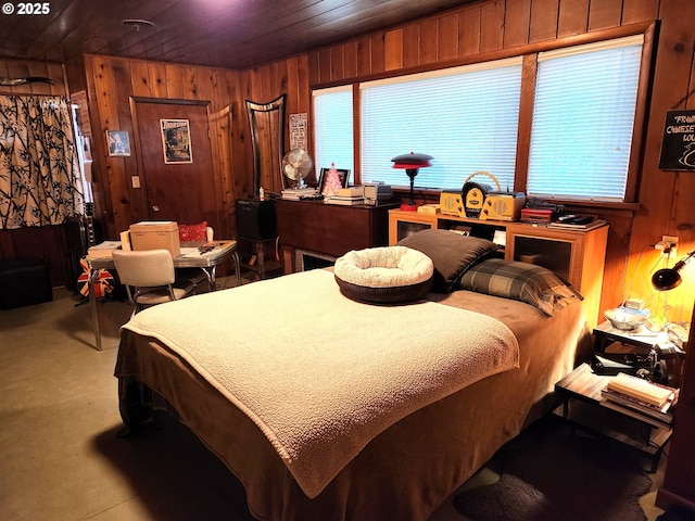 bedroom featuring wood ceiling and wooden walls