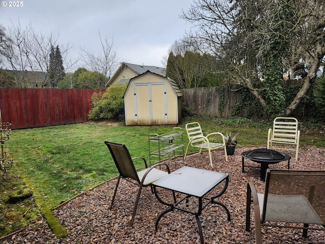 view of patio featuring a storage shed and a fire pit