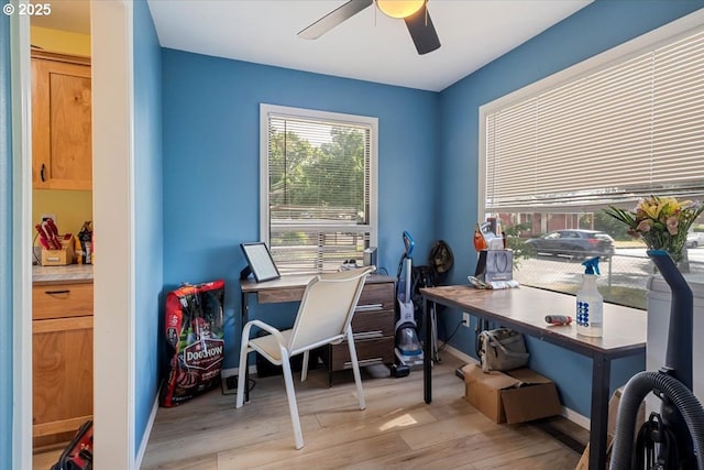 home office with ceiling fan, light wood-type flooring, and baseboards