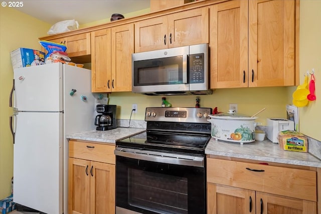 kitchen with stainless steel appliances, light countertops, and light brown cabinetry