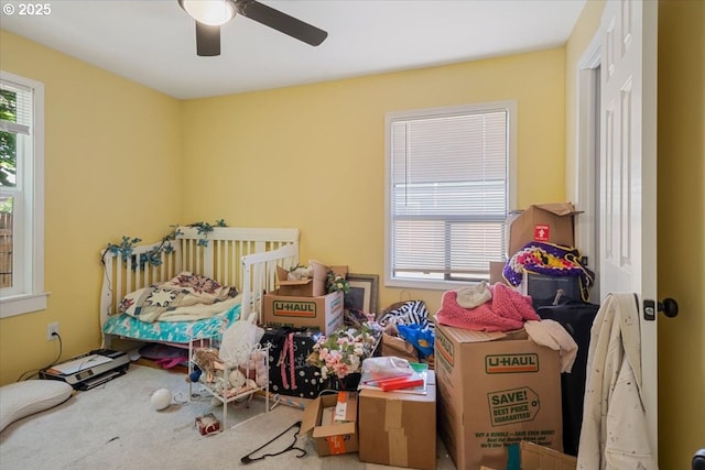 bedroom with multiple windows, carpet, and ceiling fan