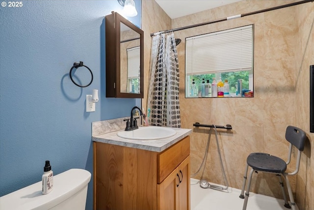 bathroom with a shower with curtain, toilet, and vanity