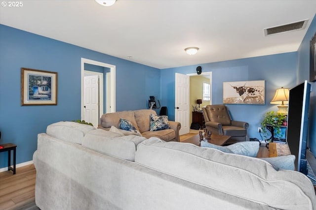 living room with wood finished floors and baseboards