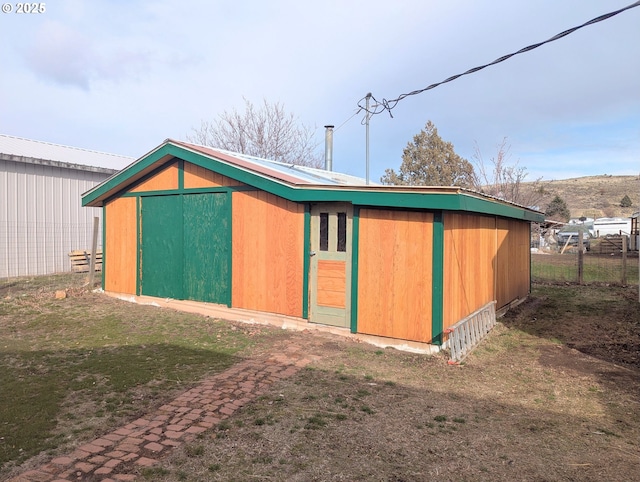 view of outbuilding with an outdoor structure and fence