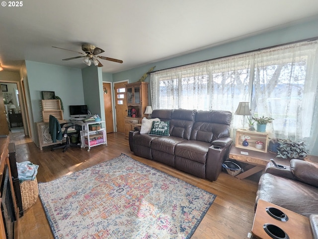 living area featuring wood finished floors and a ceiling fan