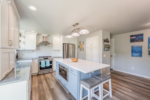 kitchen featuring wall chimney range hood, open shelves, appliances with stainless steel finishes, white cabinetry, and dark wood-style floors