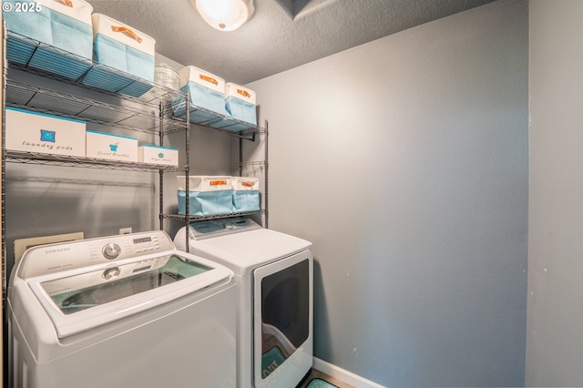 laundry room featuring baseboards, laundry area, and washer and clothes dryer