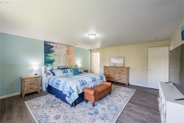 bedroom featuring baseboards and dark wood-style floors