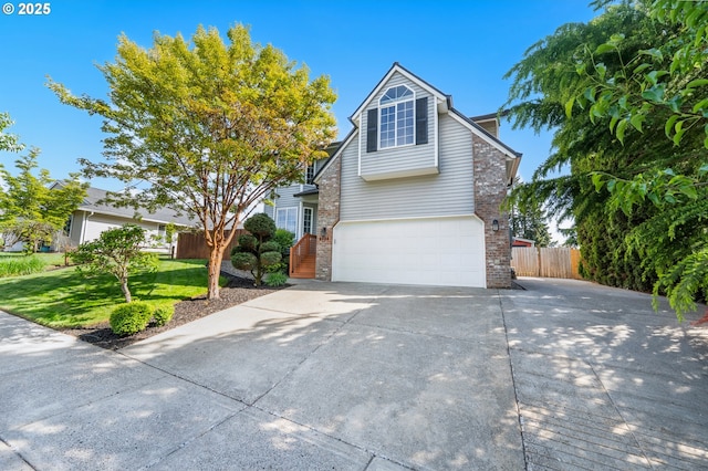 traditional-style home featuring driveway, a garage, brick siding, fence, and a front lawn