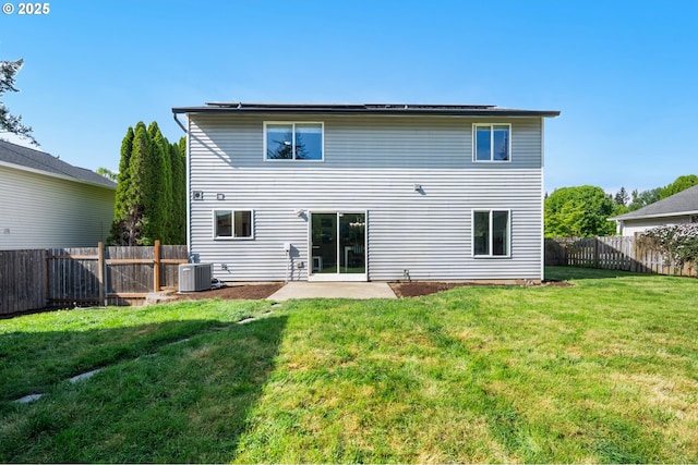 back of property with a fenced backyard, a yard, cooling unit, and a patio area
