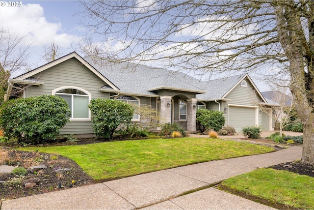 view of front of home with a garage and a front lawn