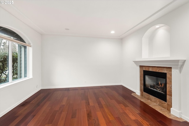 unfurnished living room featuring a fireplace and dark wood-type flooring