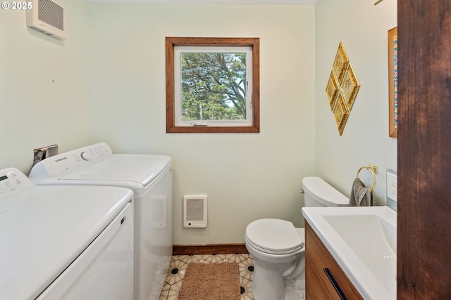 255 Coast Guard Hill Rd, Port Orford, OR 97465 - laundry room featuring washer and clothes dryer, a sink, laundry area, light tile patterned floors, and baseboards