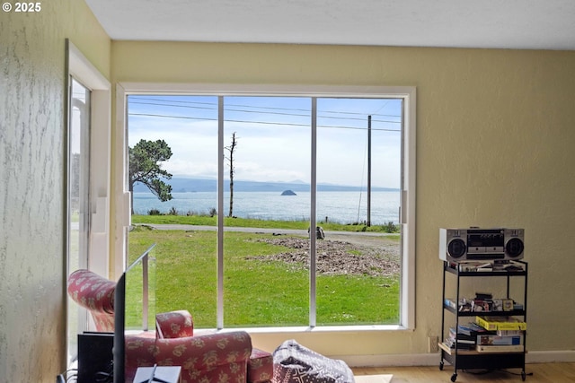 255 Coast Guard Hill Rd, Port Orford, OR 97465 - interior space featuring a water view, wood finished floors, and a healthy amount of sunlight