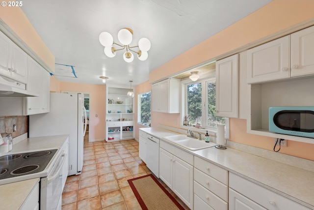 255 Coast Guard Hill Rd, Port Orford, OR 97465 - kitchen with white appliances, under cabinet range hood, a chandelier, a sink, and white cabinets