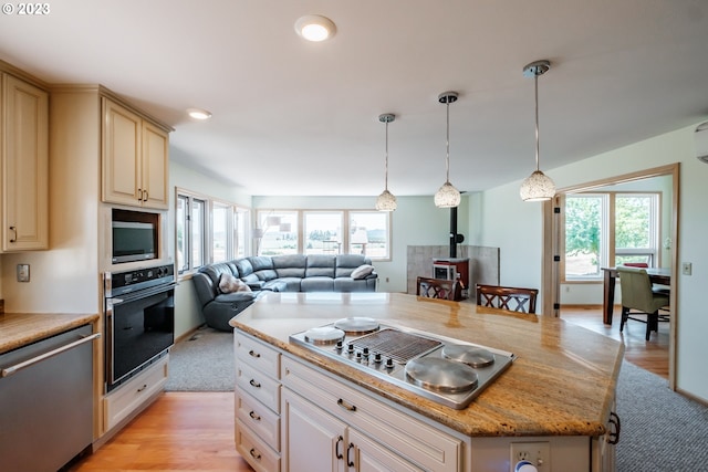 10845 Brateng Rd, Monmouth, OR 97361 - kitchen with stainless steel appliances, a wood stove, healthy amount of natural light, and open floor plan