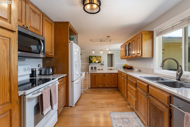 1025 S Grant St, Canby, OR 97013 - kitchen featuring stainless steel appliances, brown cabinets, light wood finished floors, and light countertops