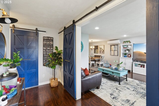 3490 Midway Ave NE, Salem, OR 97301 - foyer featuring a barn door, a wall unit AC, baseboards, wood finished floors, and recessed lighting