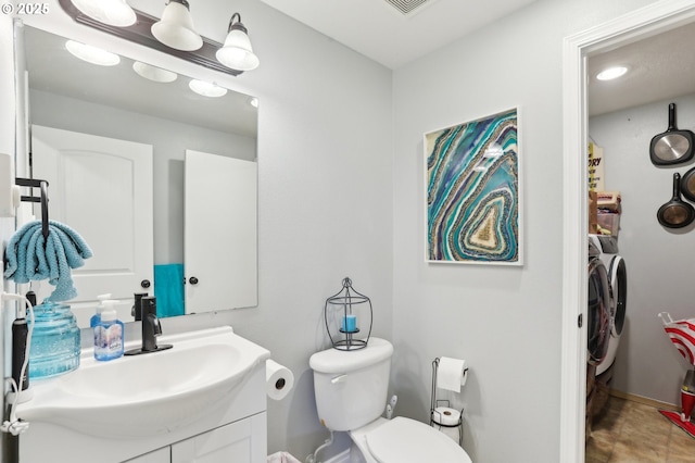 3490 Midway Ave NE, Salem, OR 97301 - bathroom featuring washing machine and clothes dryer, vanity, toilet, and baseboards