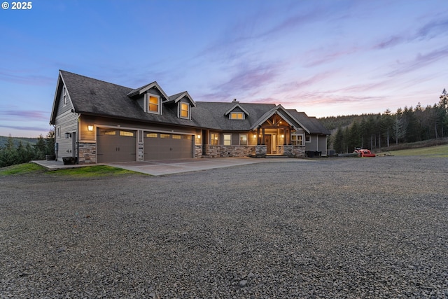 view of front of house with stone siding and concrete driveway