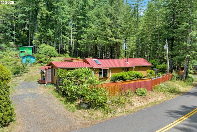 91625 W Fork Rd, Deadwood, OR 97430 - view of front of property with a wooded view, a metal roof, and gravel driveway