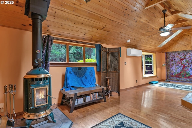 91625 W Fork Rd, Deadwood, OR 97430 - living room featuring a wood stove, wood ceiling, a wall mounted AC, wood finished floors, and ceiling fan