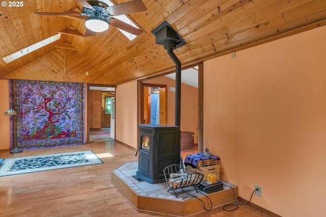 91625 W Fork Rd, Deadwood, OR 97430 - unfurnished living room with a skylight, a wood stove, wood ceiling, a ceiling fan, and vaulted ceiling