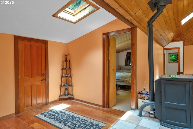 91625 W Fork Rd, Deadwood, OR 97430 - entryway featuring a skylight, light wood-type flooring, vaulted ceiling, and a wood stove