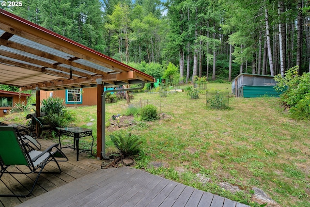 91625 W Fork Rd, Deadwood, OR 97430 - view of grassy yard with a wooden deck, a storage shed, a view of trees, and outdoor dining space