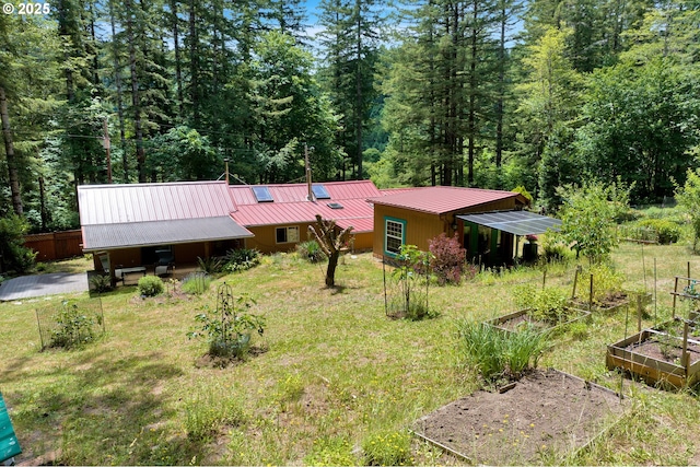 91625 W Fork Rd, Deadwood, OR 97430 - view of front of property with a vegetable garden, a metal roof, and a forest view