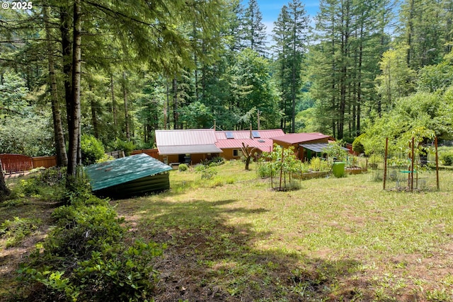 91625 W Fork Rd, Deadwood, OR 97430 - back of house with a metal roof, a wooded view, and a yard