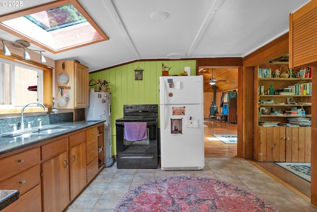 91625 W Fork Rd, Deadwood, OR 97430 - kitchen featuring freestanding refrigerator, black / electric stove, a skylight, wood walls, and vaulted ceiling