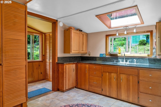 91625 W Fork Rd, Deadwood, OR 97430 - kitchen with a skylight, lofted ceiling, plenty of natural light, and dark stone counters