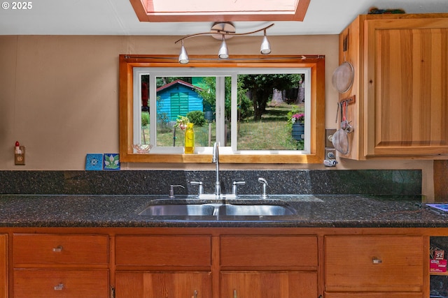 91625 W Fork Rd, Deadwood, OR 97430 - kitchen featuring dark stone counters and brown cabinetry